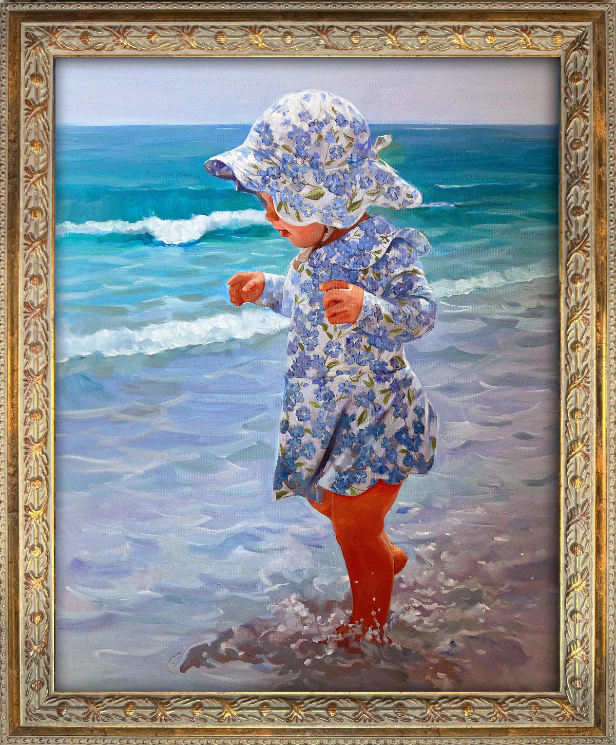Custom hand-painted oil portrait of a young child playing at the ocean’s edge in a floral sun hat and dress, recreated from a family beach photo.