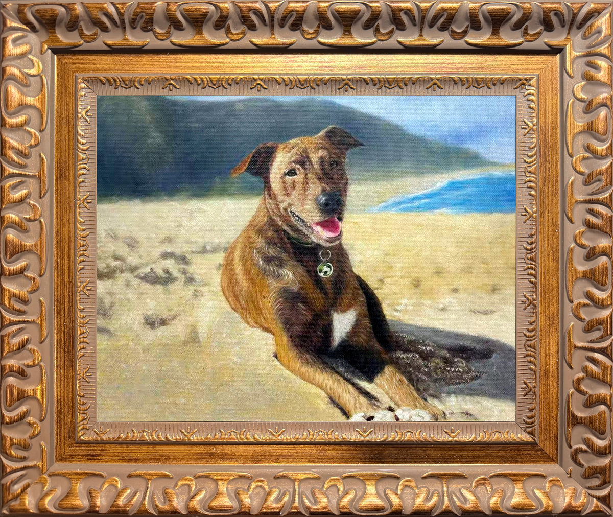 Custom hand-painted oil portrait of a brown dog relaxing on a beach, created from a pet photo with ocean and mountain scenery in the background.