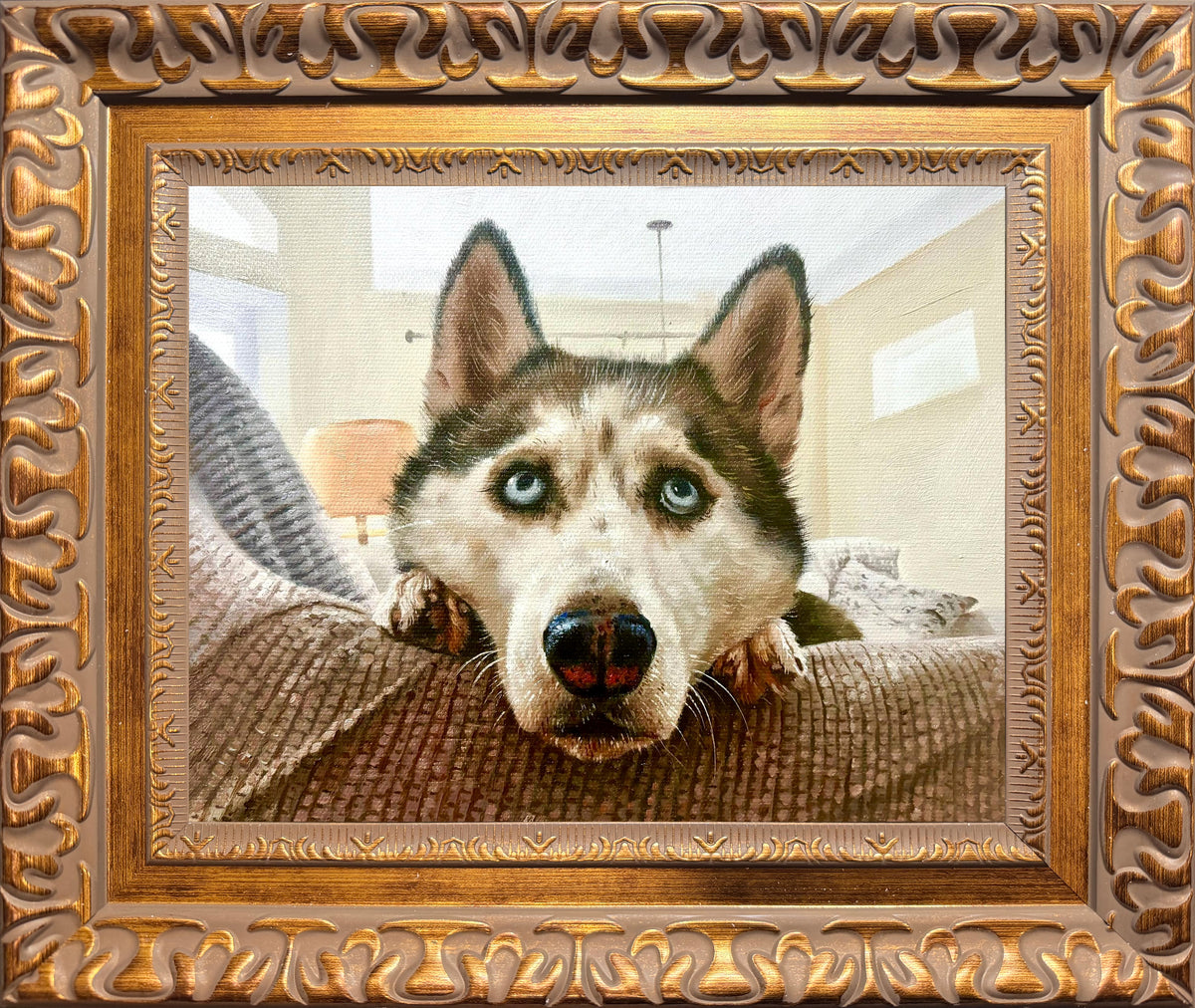 Realistic hand-painted oil portrait of a blue-eyed husky resting on a couch, created from a pet photo and displayed in an ornate gold frame.